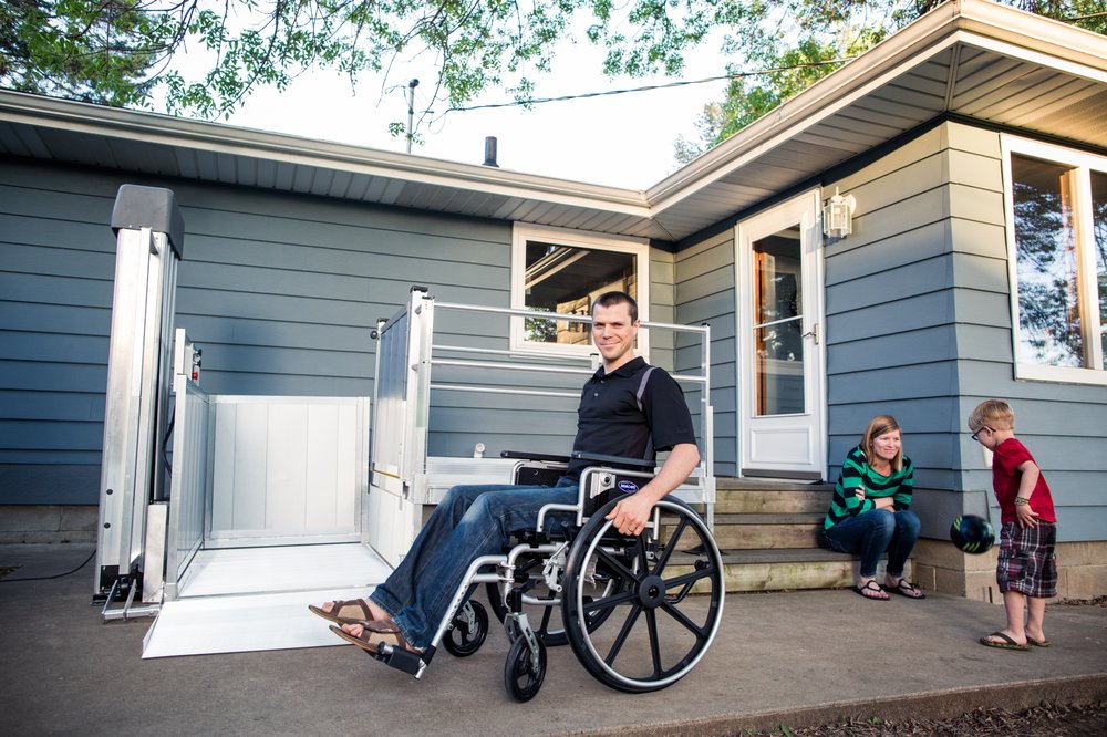 A man about to use an accessibility lift while in a wheelchair.