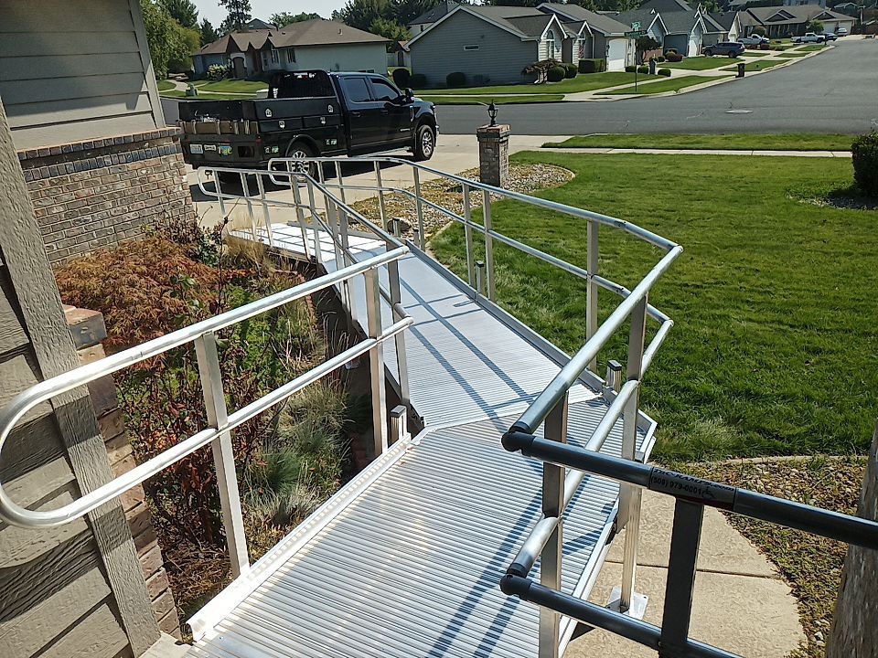 A ramp that leads from the driveway to the front door.