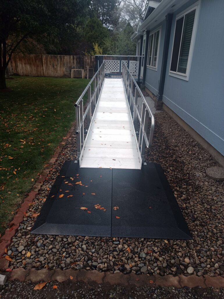 A stainless steel ramp in combination with a rubber mat for traction at the base.