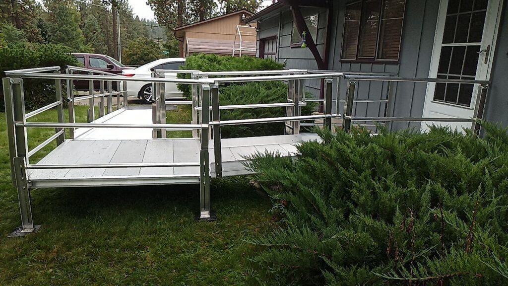 An aluminum ramp attached to the front of a house.